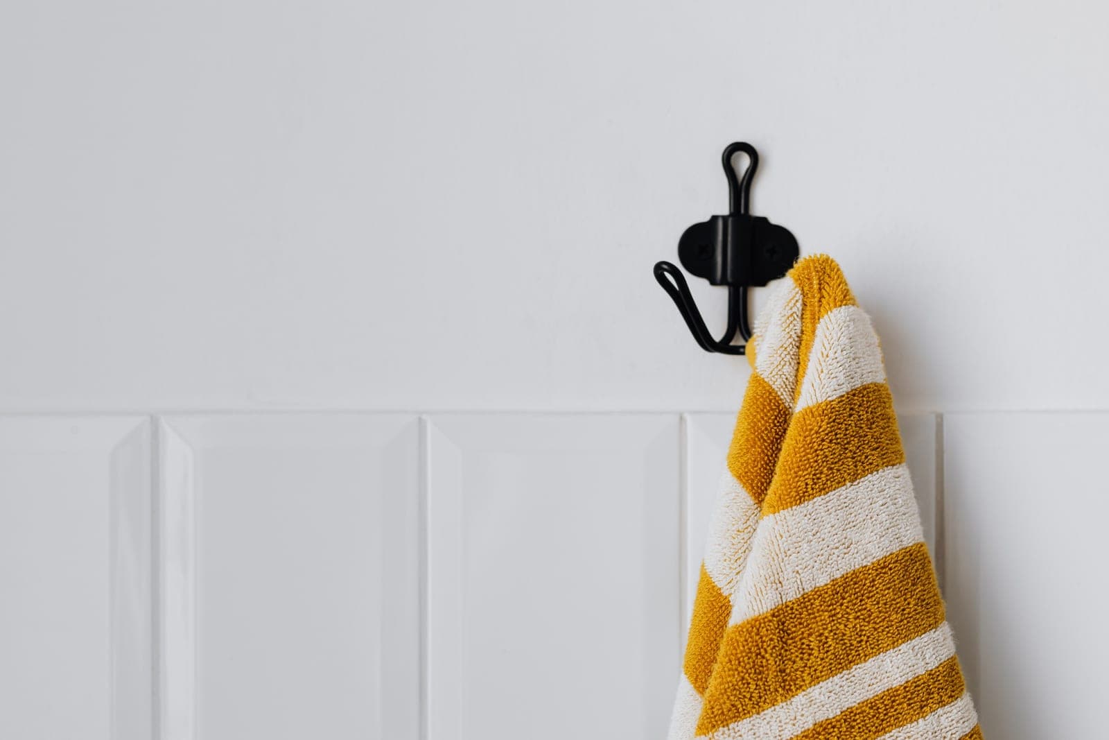 A bright bathroom with towels hanging to dry