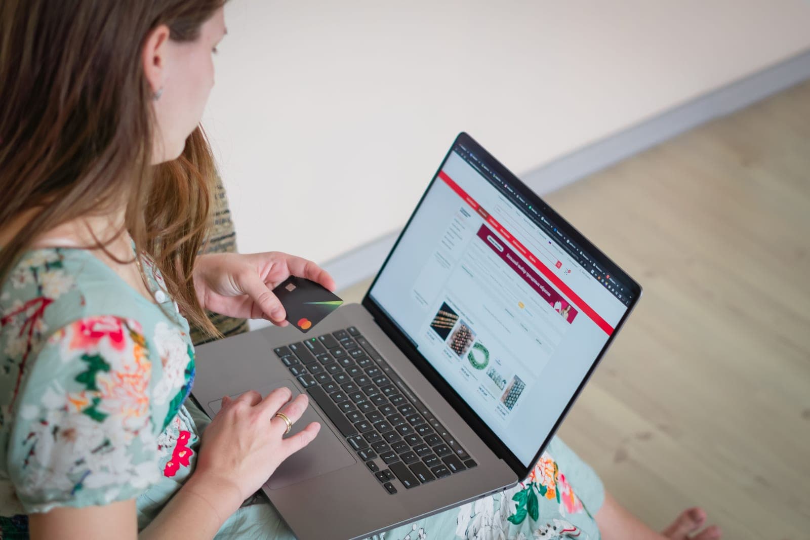Shopping online on a laptop at a kitchen table