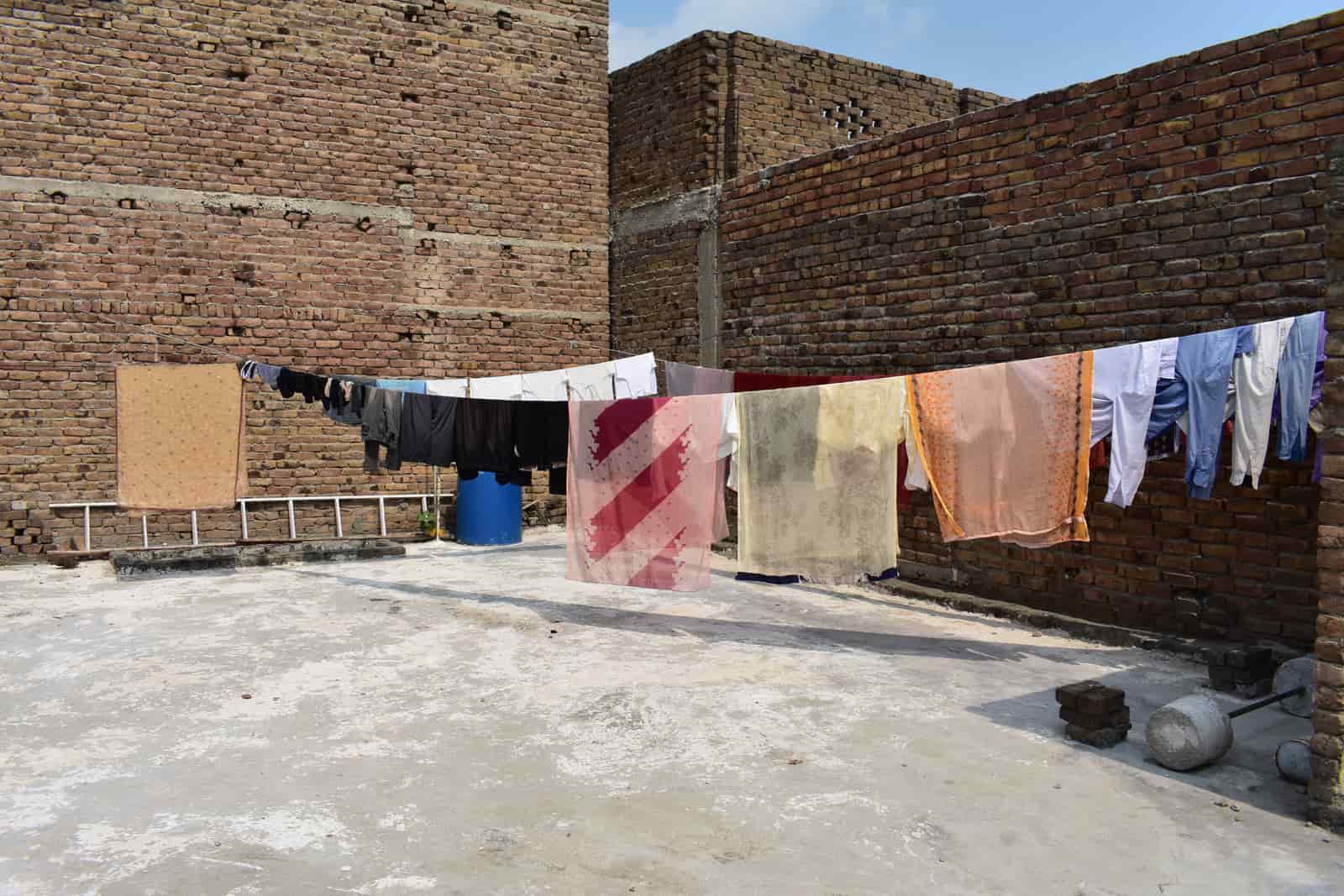 Laundry hanging on a line under a bright blue sky
