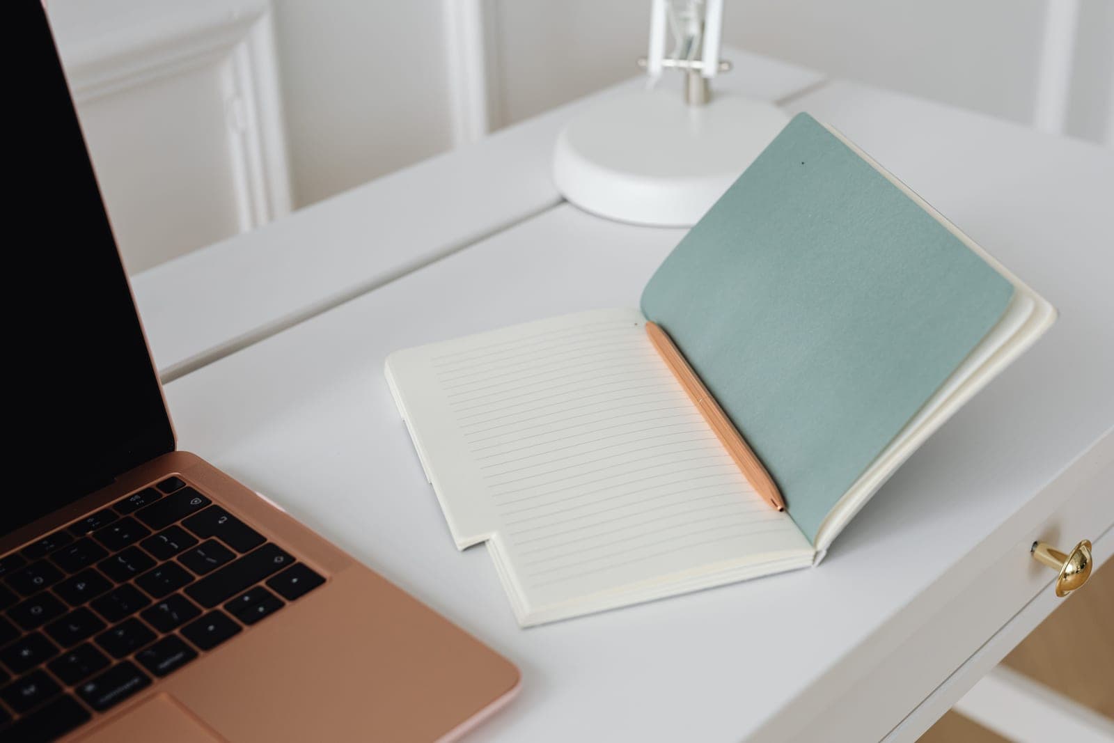 An open notebook and a pen on a clean desk