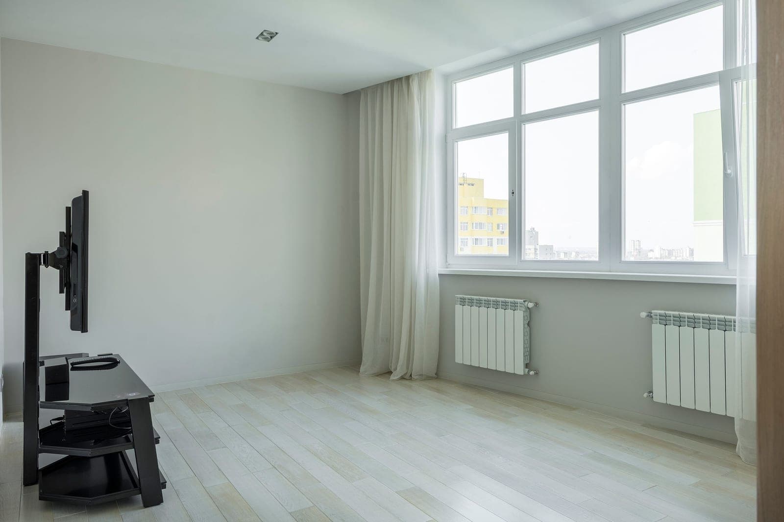 A home radiator beneath a bright window
