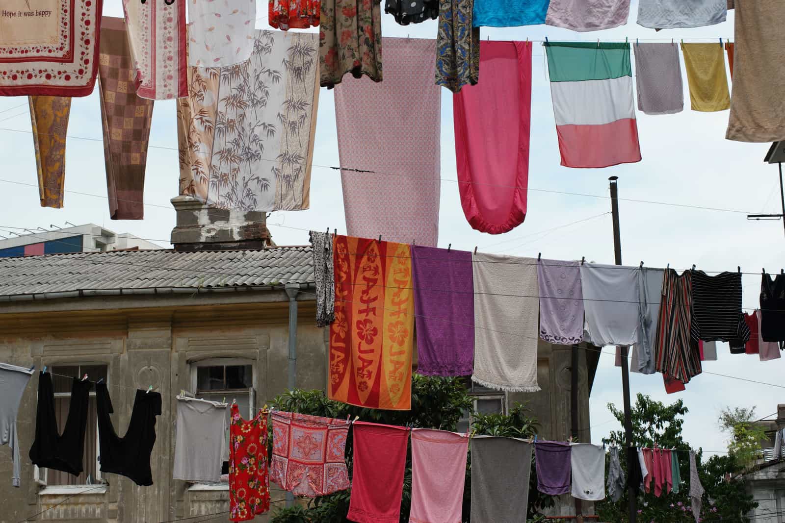 White bed sheets hanging on a washing line in daylight