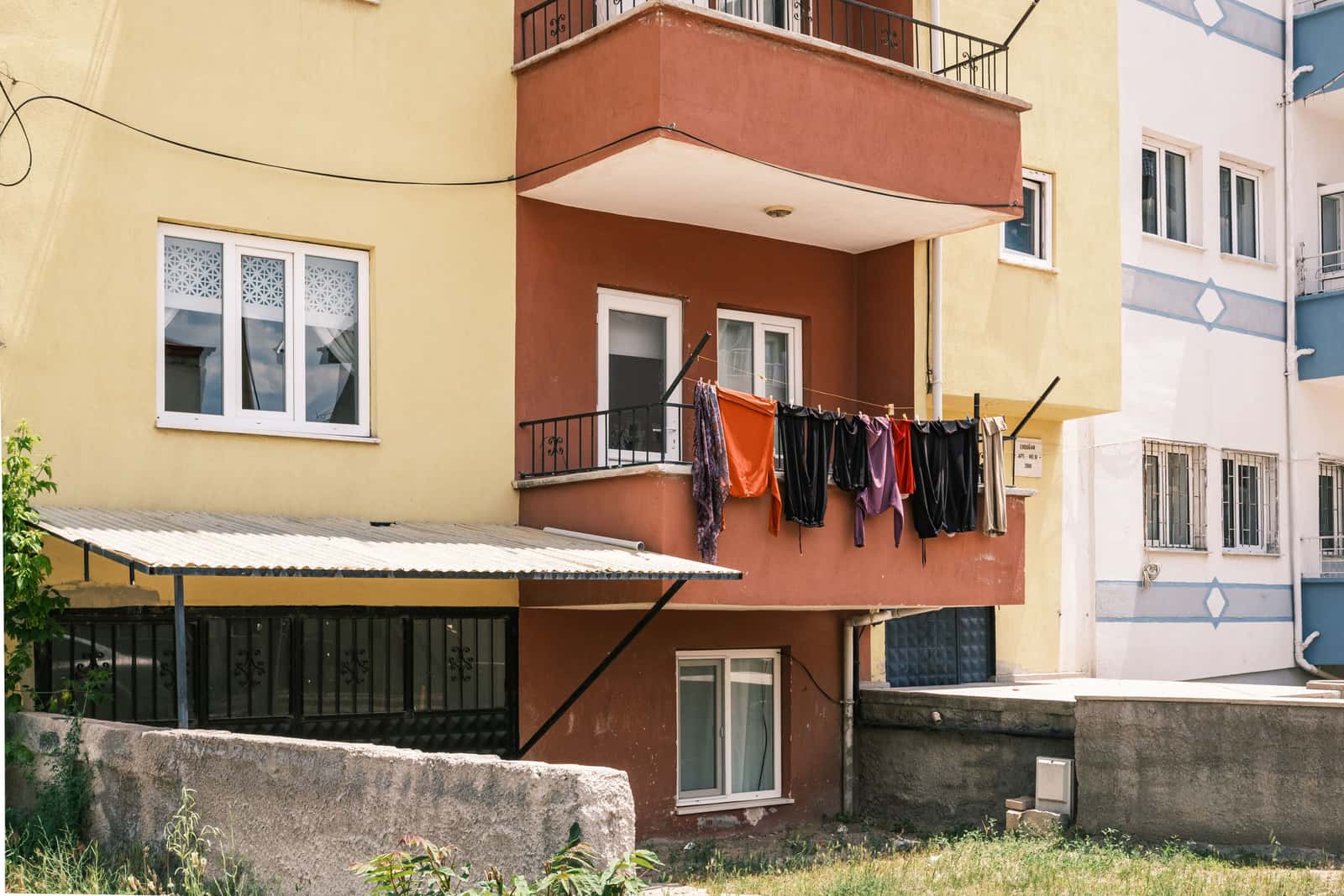 A small balcony with laundry drying in the sun