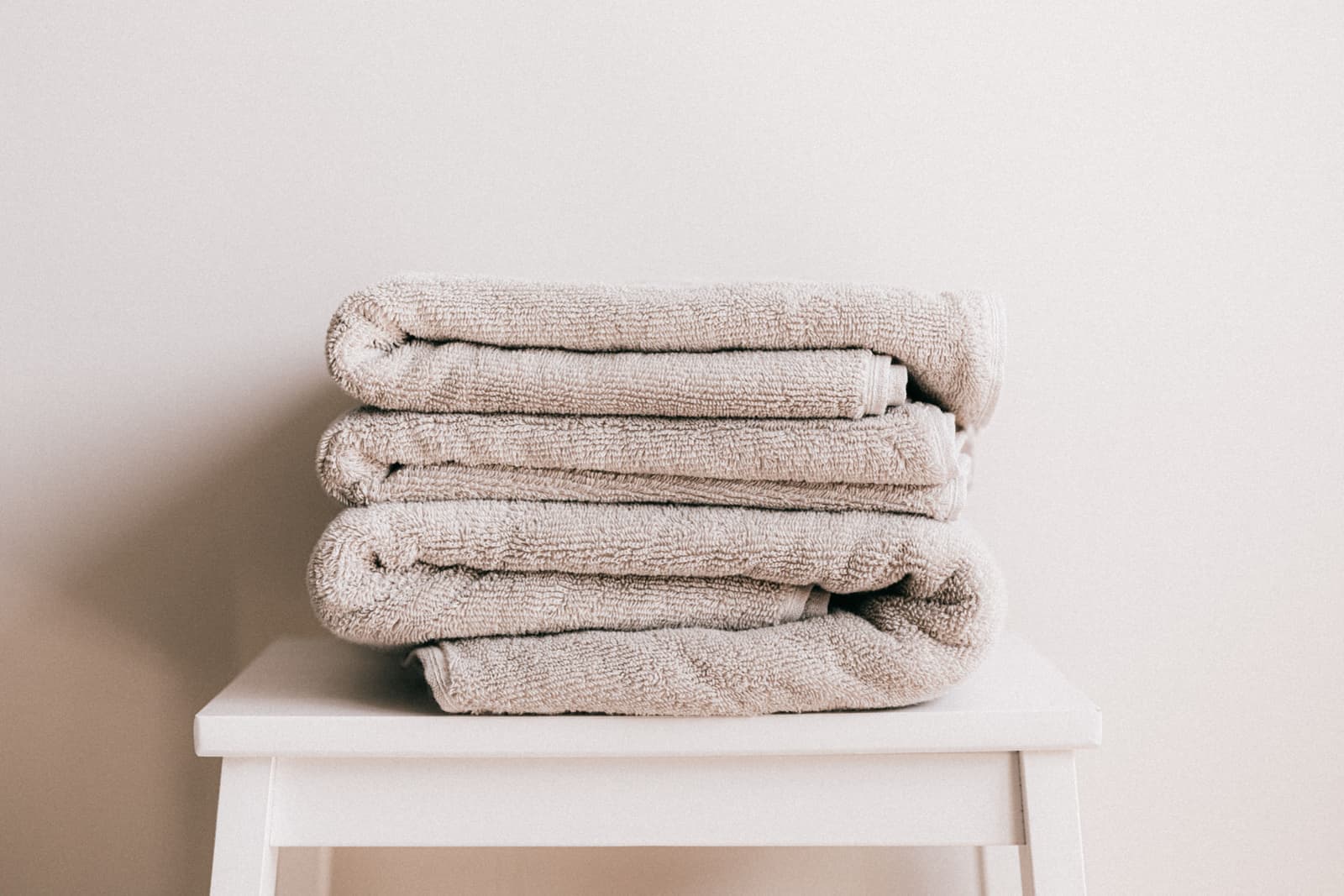 Folded towels in a clean, bright bathroom