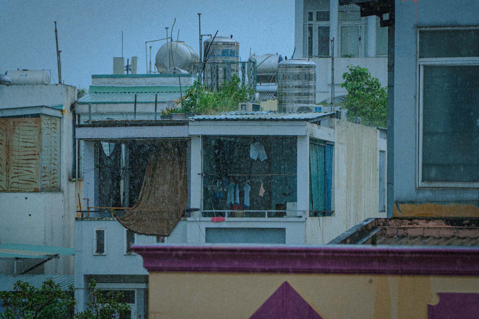 Rain on a window with laundry drying indoors